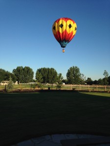 And THIS is what we woke up to Sunday morning! We heard a strange noise and went outside to see what it was... and it was a hot air balloon sailing right over the top of our house! It was really neat.